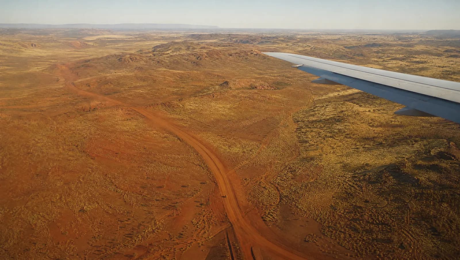 View from a plane window over the red earth of the Pilbara